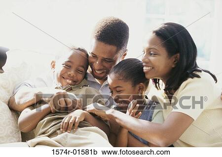 Stock Image - Parents playing with their son and daughter. Fotosearch