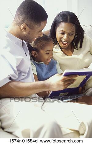 Parents reading a book with their daughter View Large Photo Image Stock Image - Parents reading a book with their daughter. Fotosearch