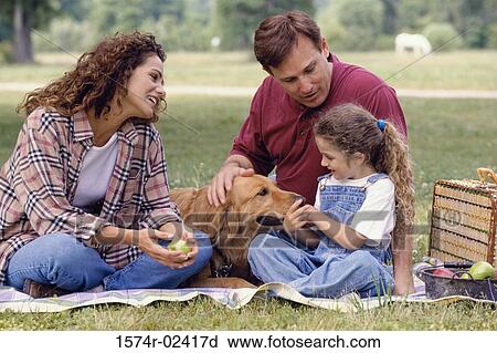 Parents with their daughter and a dog View Large Photo Image Stock Image - Parents with their daughter and a dog. Fotosearch