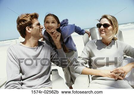 Parents with their daughter on the beach View Large Photo Image Stock Image - Parents with their daughter on the beach. Fotosearch