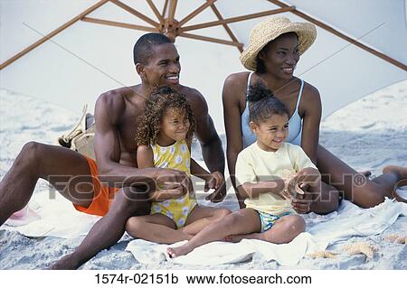 Parents with their daughters on the beach View Large Photo Image Stock Image - Parents with their daughters on the beach. Fotosearch