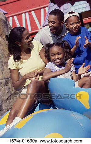 Parents with their son and daughter at an amusement park View Large Photo Image Stock Image - Parents with their son and daughter at an amusement park. Fotosearch