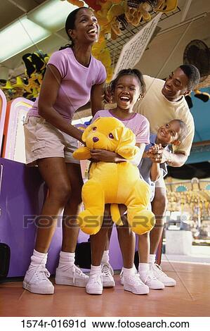Parents with their son and daughter at an amusement park View Large Photo Image Stock Image - Parents with their son and daughter at an amusement park. Fotosearch
