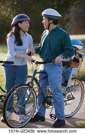Parents with their son wearing cycling helmets View Large Photo Image Stock Image - Parents with their son wearing cycling helmets. Fotosearch