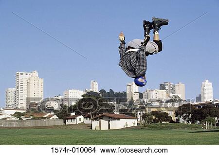 Picture - Person flipping in mid air wearing inline skates. Fotosearch
