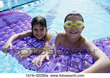 Portrait of a boy and a girl leaning on a pool raft View Large Photo Image Stock Image - Portrait of a boy and a girl leaning on a pool raft. Fotosearch