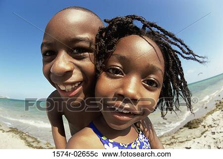 Portrait of a boy and a girl playing on the beach View Large Photo Image Stock Image - Portrait of a boy and a girl playing on the beach. Fotosearch