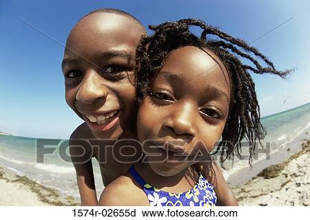 Portrait of a boy and a girl playing on the beach View Large Photo Image Stock Image - Portrait of a boy and a girl playing on the beach. Fotosearch
