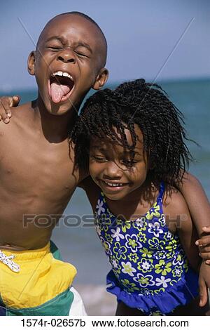 Portrait of a boy and a girl playing on the beach View Large Photo Image Stock Image - Portrait of a boy and a girl playing on the beach. Fotosearch