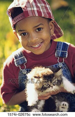 Portrait of a boy holding a cat View Large Photo Image Stock Image - Portrait of a boy holding a cat. Fotosearch
