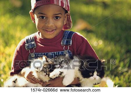 Portrait of a boy holding cats View Large Photo Image Stock Image - Portrait of a boy holding cats. Fotosearch