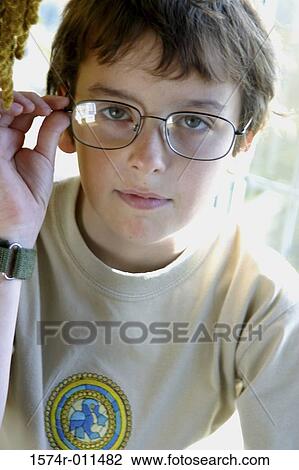 Portrait of a boy holding his eyeglasses View Large Photo Image Stock Image - Portrait of a boy holding his eyeglasses. Fotosearch