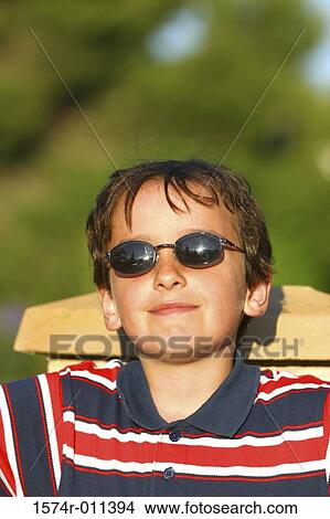 Portrait of a boy sitting on a chair View Large Photo Image Picture - Portrait of a boy sitting on a chair. Fotosearch