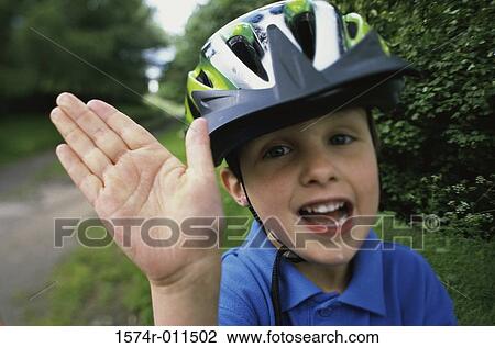 Stock Image - Portrait of a boy wearing a helmet and smiling. Fotosearch