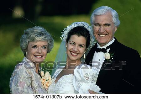 Stock Image - Portrait of a bride standing with her parents. Fotosearch