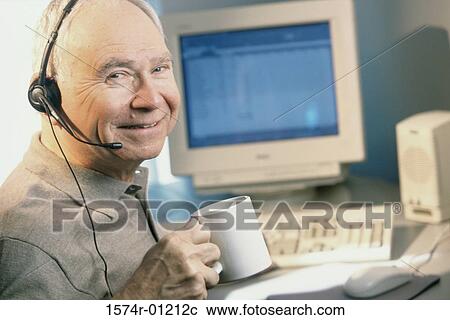 Stock Image - Portrait of a businessman holding a coffee cup. Fotosearch