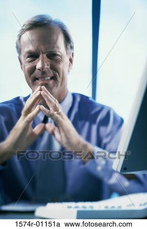 Stock Image - Portrait of a businessman smiling. Fotosearch