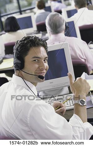 Portrait of a businessman wearing a headset with businesspeople in the background View Large Photo Image Stock Image - Portrait of a businessman wearing a headset with businesspeople in the background. Fotosearch