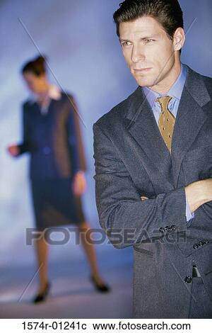 Stock Image - Portrait of a businessman with a businesswoman behind her. Fotosearch