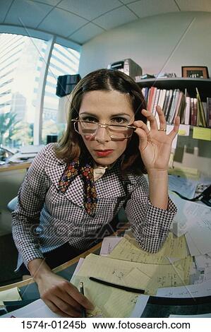 Portrait of a businesswoman adjusting her eyeglasses View Large Photo Image Stock Image - Portrait of a businesswoman adjusting her eyeglasses. Fotosearch