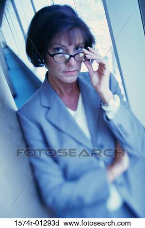 Portrait of a businesswoman adjusting her eyeglasses View Large Photo Image Stock Image - Portrait of a businesswoman adjusting her eyeglasses. Fotosearch
