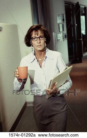 Portrait of a businesswoman holding a cup of coffee and files View Large Photo Image Stock Image - Portrait of a businesswoman holding a cup of coffee and files. Fotosearch