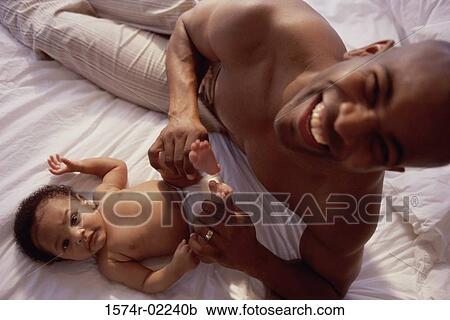 Portrait of a father holding his baby boy's feet View Large Photo Image Stock Image - Portrait of a father holding his baby boy's feet. Fotosearch