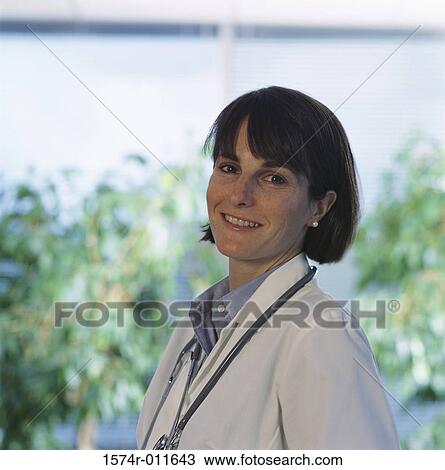 Stock Image - Portrait of a female doctor standing outdoors. Fotosearch