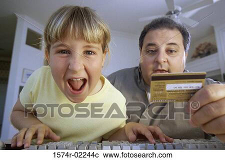 Portrait of a girl and her father in front of a computer View Large Photo Image Stock Image - Portrait of a girl and her father in front of a computer. Fotosearch