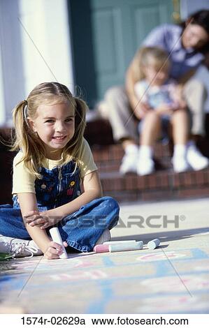Portrait of a girl drawing on the floor with chalk View Large Photo Image Stock Image - Portrait of a girl drawing on the floor with chalk. Fotosearch