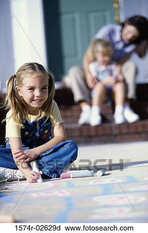 Portrait of a girl drawing on the floor with chalk View Large Photo Image Stock Image - Portrait of a girl drawing on the floor with chalk. Fotosearch