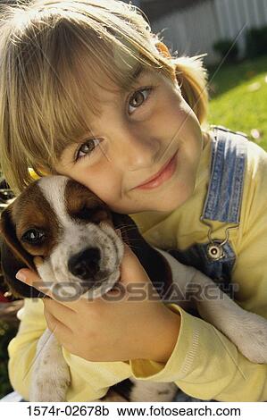 Portrait of a girl holding her puppy View Large Photo Image Stock Image - Portrait of a girl holding her puppy. Fotosearch