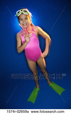 Portrait of a girl in swimsuit holding a starfish View Large Photo Image Stock Image - Portrait of a girl in swimsuit holding a starfish. Fotosearch