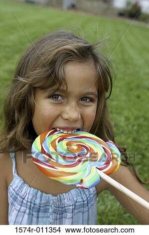 Portrait of a girl licking a lollipop View Large Photo Image Picture - Portrait of a girl licking a lollipop. Fotosearch