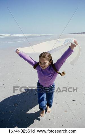 Portrait of a girl running on the beach View Large Photo Image Stock Image - Portrait of a girl running on the beach. Fotosearch
