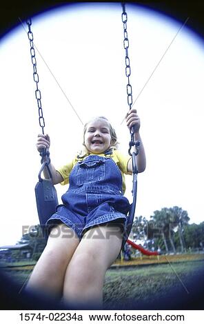 Portrait of a girl sitting on a swing View Large Photo Image Stock Image - Portrait of a girl sitting on a swing. Fotosearch