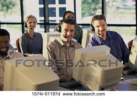 Stock Image - Portrait of a group of business executives working on computers. Fotosearch