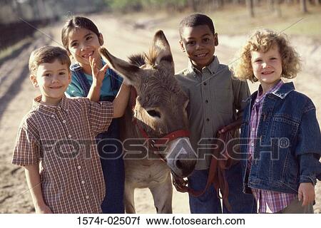 Portrait of a group of children standing with a donkey View Large Photo Image Stock Image - Portrait of a group of children standing with a donkey. Fotosearch