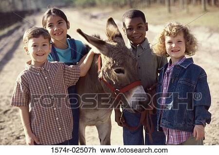 Portrait of a group of children standing with a donkey View Large Photo Image Stock Image - Portrait of a group of children standing with a donkey. Fotosearch