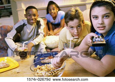 Portrait of a group of children watching television View Large Photo Image Stock Image - Portrait of a group of children watching television. Fotosearch