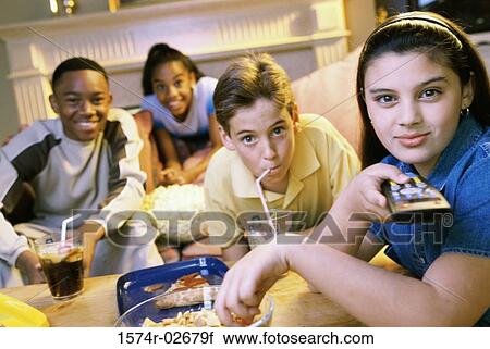 Portrait of a group of children watching television View Large Photo Image Stock Image - Portrait of a group of children watching television. Fotosearch