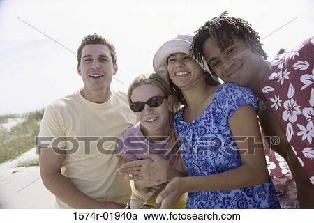 Stock Image - Portrait of a group of teenagers smiling. Fotosearch