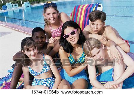 Portrait of a group of teenagers sitting beside a swimming pool View Large Photo Image Stock Image - Portrait of a group of teenagers sitting beside a swimming pool. Fotosearch