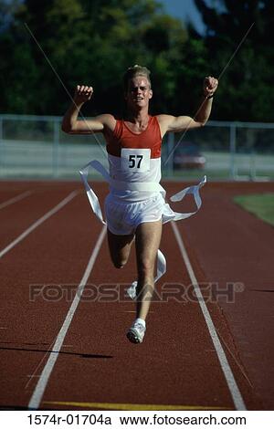 Portrait of a male runner crossing the finishing line with his arms raised View Large Photo Image Stock Image - Portrait of a male runner crossing the finishing line with his arms raised. Fotosearch