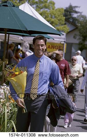 Portrait of a man holding a bouquet of flowers View Large Photo Image Stock Photo - Portrait of a man holding a bouquet of flowers. Fotosearch
