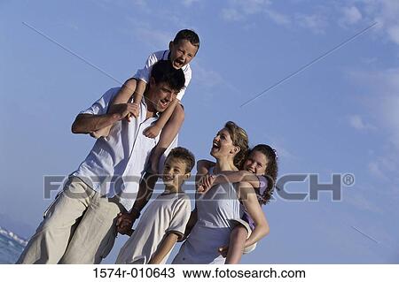 Portrait of a mother and father on the beach with their three children View Large Photo Image Stock Image - Portrait of a mother and father on the beach with their three children. Fotosearch