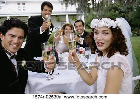 Portrait of a newlywed couple and their friends toasting with champagne glasses View Large Photo Image Stock Image - Portrait of a newlywed couple and their friends toasting with champagne glasses. Fotosearch