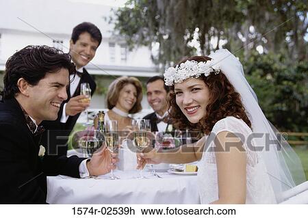Portrait of a newlywed couple and their friends toasting with champagne glasses View Large Photo Image Stock Image - Portrait of a newlywed couple and their friends toasting with champagne glasses. Fotosearch