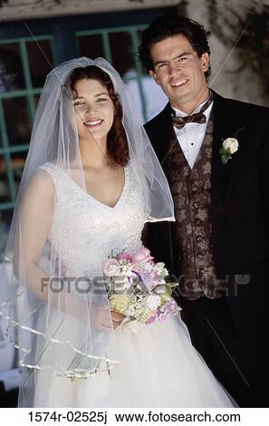 Portrait of a newlywed couple smiling View Large Photo Image Stock Image - Portrait of a newlywed couple smiling. Fotosearch