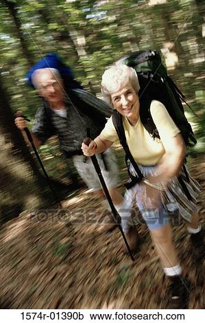Stock Image - Portrait of a senior couple hiking. Fotosearch